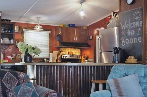 View toward kitchen with amenities like wine glass rack, cork thingy, and sink!