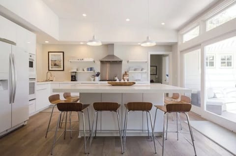 Kitchen with large glass doors to enter backyard and pool