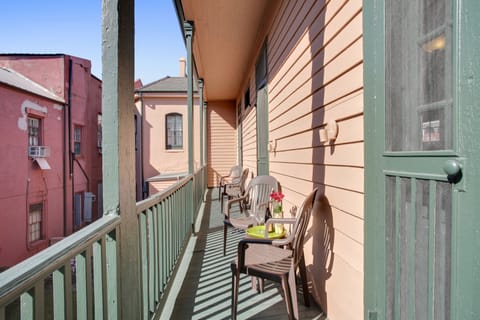 Enjoy a glass of wine on the private balcony overlooking the courtyard