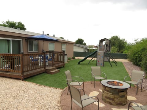 AMAZING Fenced backyard with playset, Firepit, BBQ, and sitting area