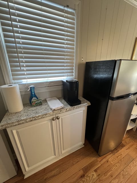 Smaller fridge freezer provided with Keruig coffee maker.