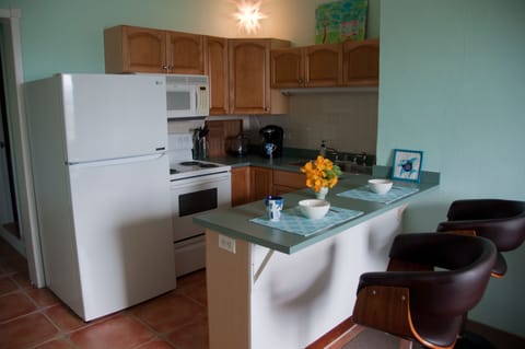 Kitchen with new stove and refrigerator.