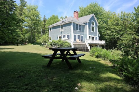 Large side yard with shaded picnic table