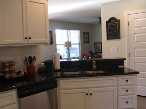 Kitchen with granite counter tops and full stocked cabinets.