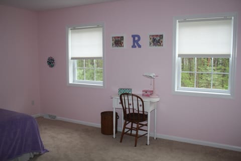 Guest bedroom #1 that receives a lot of light and looks out over pool