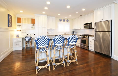 Open kitchen adjacent to great room where couch and dining/billiards are.