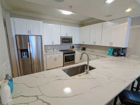 Kitchen: Sleek appliances and stunning marble countertops—perfect for culinary adventures!