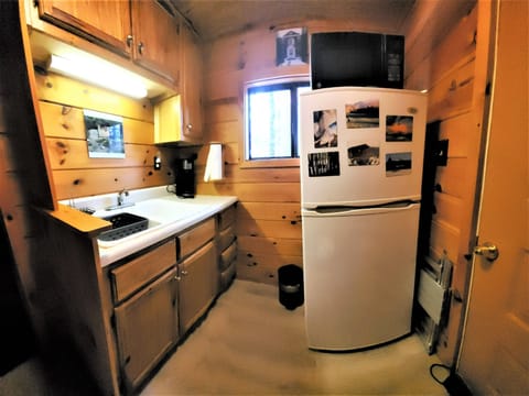 Kitchen with sink, refrigerator, and microwave and snacks!  