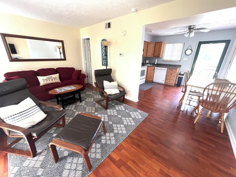 LIVING ROOM OPENS TO THE KITCHEN AREA.. STORM DOOR & SLIDING DOORS = LIGHT!