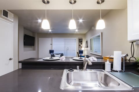 View of TV from Kitchen.  Dimmable pendant lights over bar.