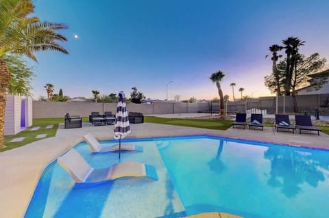 Private resort-style pool with wet deck loungers and spacious backyard