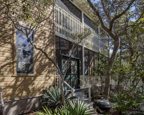 The screened porch looks out to a lush garden of native Florida
