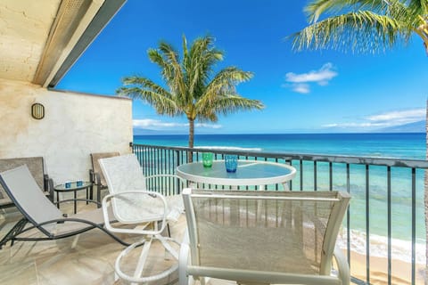 Lokelani B-204's sun balcony with direct oceanfront views and a quiet sandy beach.