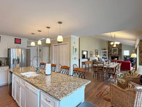 Island seats 4 + 10 seats at the Dining Area table.  The open floor plan is ideal for family or large group gatherings