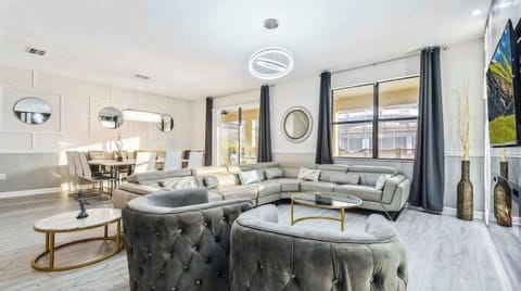 Elegant living room, grandly appointed with a focal TV for luxurious entertainment and relaxation