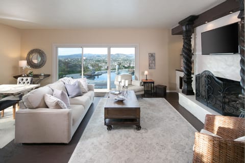 Living area overlooking heated salt water pool and city below.