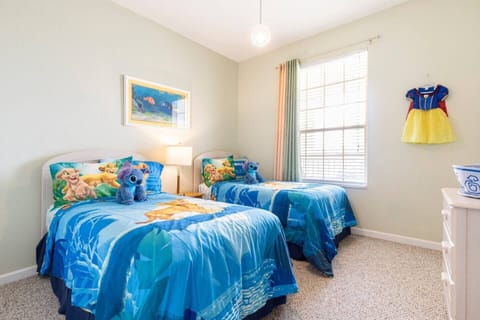 Disney-esque kids’ bedroom has two twin beds, a walk-in closet, and a bathroom.