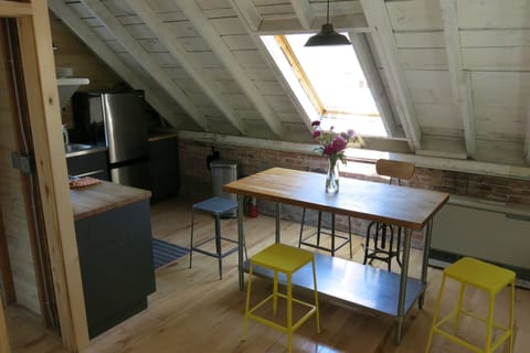 A large butcher block table serves dual purpose for dining or prepping your meal
