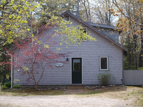 Driveway side of cottage with parking area