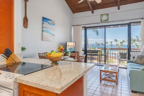 Prepare meals while enjoying panoramic views of the ocean and lush greenery from the spacious kitchen island