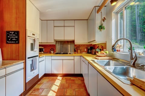 Sunny kitchen is well stocked!  Double ovens, gas cooktop, Bosch dishwasher