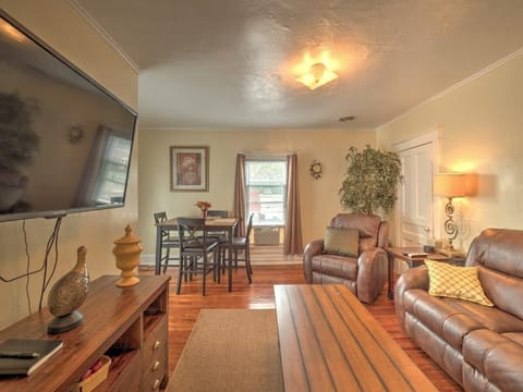 Living room with a dining area, 50" flat screen TV mounted to the wall and 145+ channels on DirecTV.