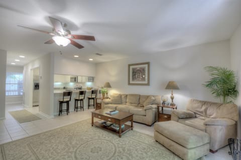 Living Room – Bright, Airy Comfort Near St. Simons Beaches - Spacious and sunlit, this open-concept living room offers the perfect place to unwind after exploring St. Simons Island. Coastal tones, plush seating, and direct sightlines to the kitchen make it ideal for gathering with family or friends just minutes from the beach.