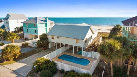 Beachfront vacation home with private pool, just steps from pristine white sand and turquoise waters.