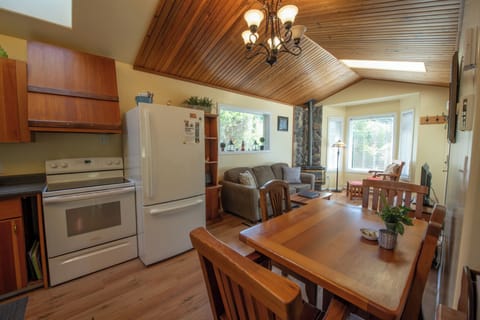 Living room with bay window and gas fireplace, kitchen and dining