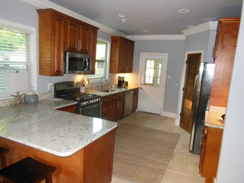 kitchen with eat-in bar that seats 3 people