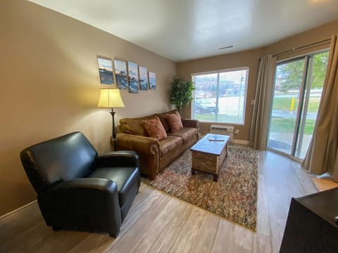 Charming living space with plush seating and natural light, perfect for relaxing or entertaining.