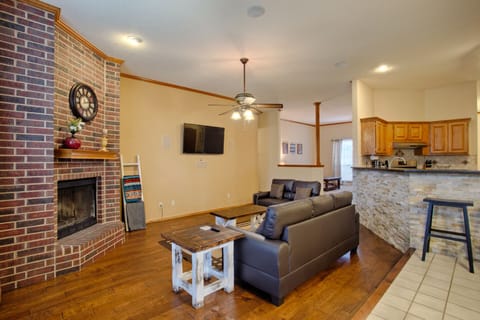 Living room with couch, love seat, 55 inch TV and gas fireplace