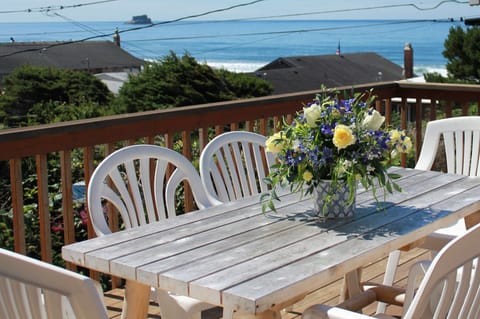 table on deck of home, overlooking the ocean and Castle Rock