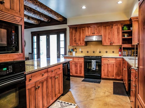 Kitchen from Entryway - A photo of the kitchen from the entryway showing the exterior doors to the grill.