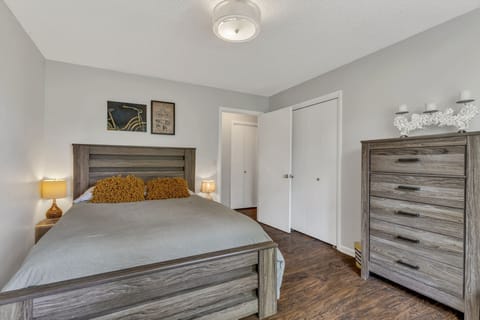 Bedroom 1, with queen bed, closet with lots of hangers, and 5-drawer dresser