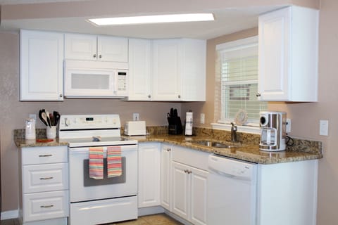 White kitchen with new cabinets and granite
