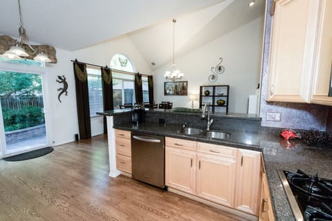 Kitchen has door to fenced back yard.