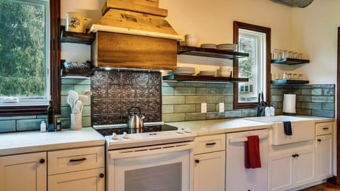 New kitchen boasts a farm sink, double ovens, reclaimed wood shelving. All you need for host your large group including big stock pots and many dishes!