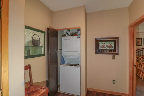 Stackable washer dryer in the condo.  Iron and ironing board.
