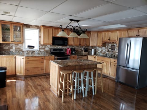 Fully stocked kitchen with dishwasher, double oven/stove, microwave and frig.