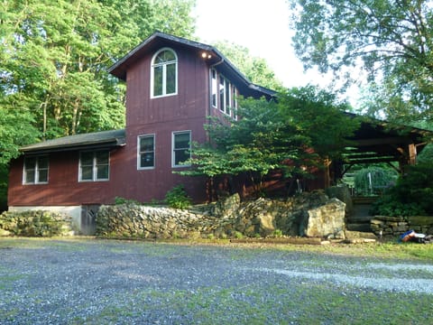 Secluded post-and-beam construction home surrounded by woods.