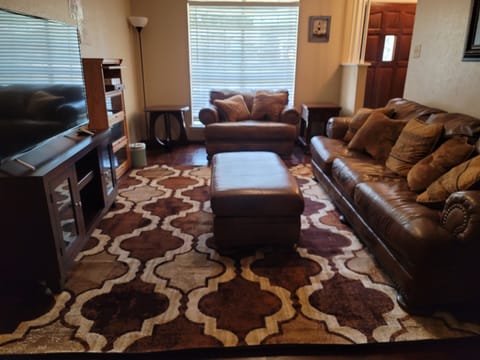 Living Room with 55 in TCL Roku TV; Big comfortable leather sofa and loveseat