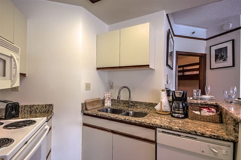 Fully-stocked kitchen with everything needed for cooking. Granite countertops.