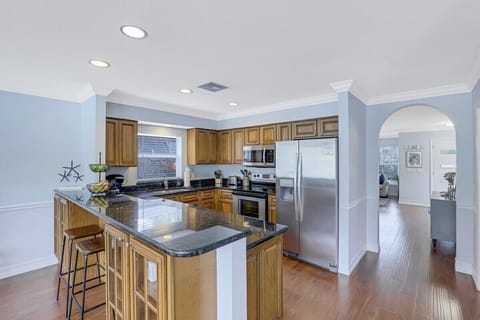 Stainless appliances and easy access to dining area just thru arch