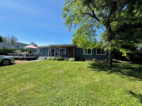 front yard w/deck, lake views. Lg driveway accommodates cars/boat ttailers