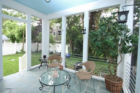 Gorgeous rear screened porch leading to the yard with 3 barbecues.