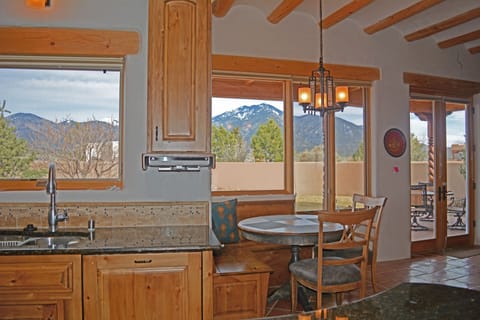 East facing window wall from kitchen to breakfast dining to living room fireplace + full length covered patio all for panoramic mountain viewing