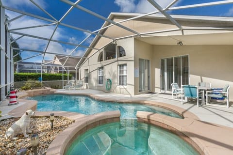 Relax by the private screened-in pool with crystal-clear water and ample lounging space.