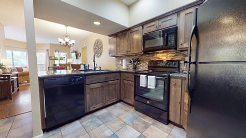 Upgraded kitchen with black appliances.