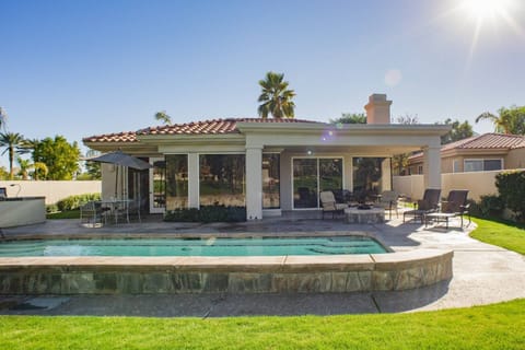 View from Golf Course of back patio, pool, BBQ and Fire Pit